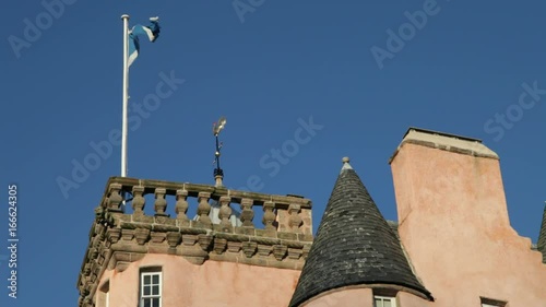 The Scottish National Flag, the Saltire or St. Andrews Cross, flying from the top of Craigievar Castle in Aberdeenshire photo