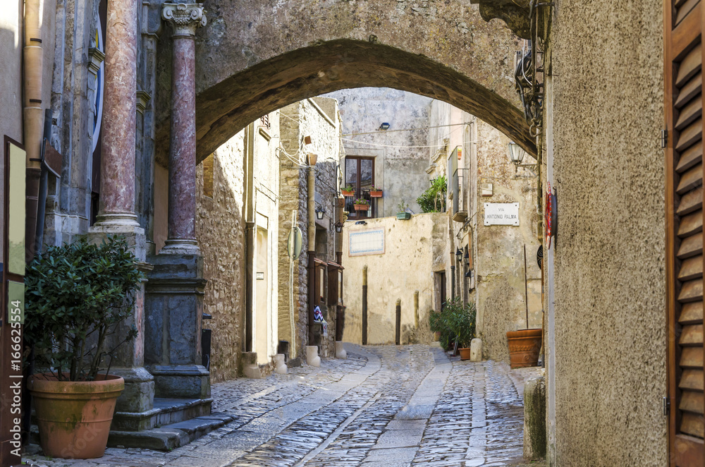 View of a street of erice with gothic arch