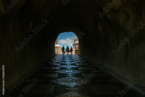 Perspective of claustrophobic underground walkway tunnel in Algarve Portugal, light at the end of the tunnel.