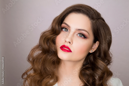 Portrait of a beautiful young girl with makeup and hairstyle