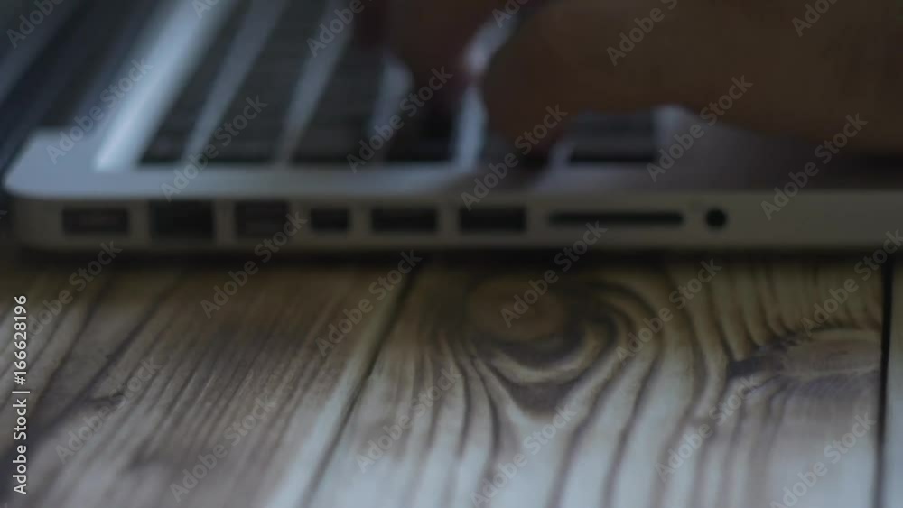 Hands typing on the keyboard. Man typing. wooden background Hands typing on the keyboard. Man typing. wooden background