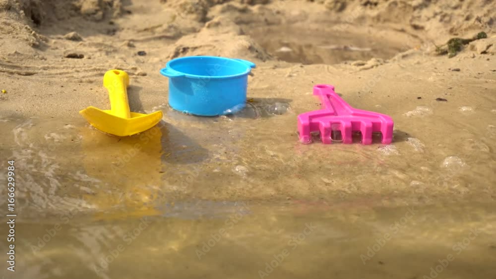 Children's toys on the beach of the lake Children's toys on the beach of the lake