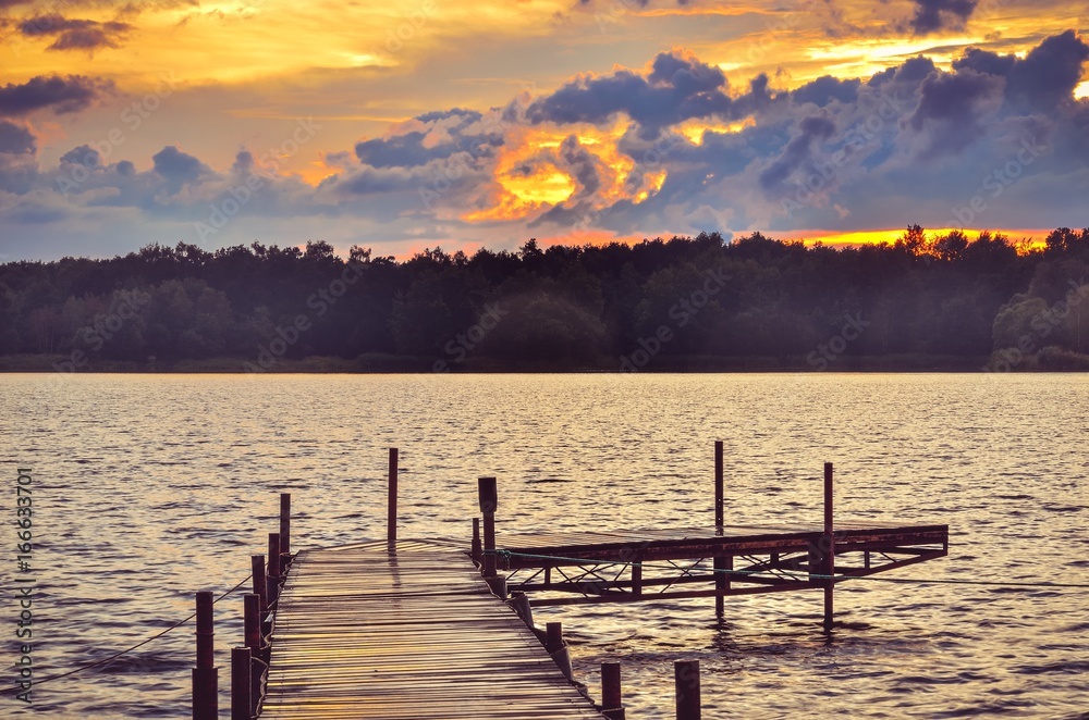 Wooden pier on the lake. Evening landscape on the lake.