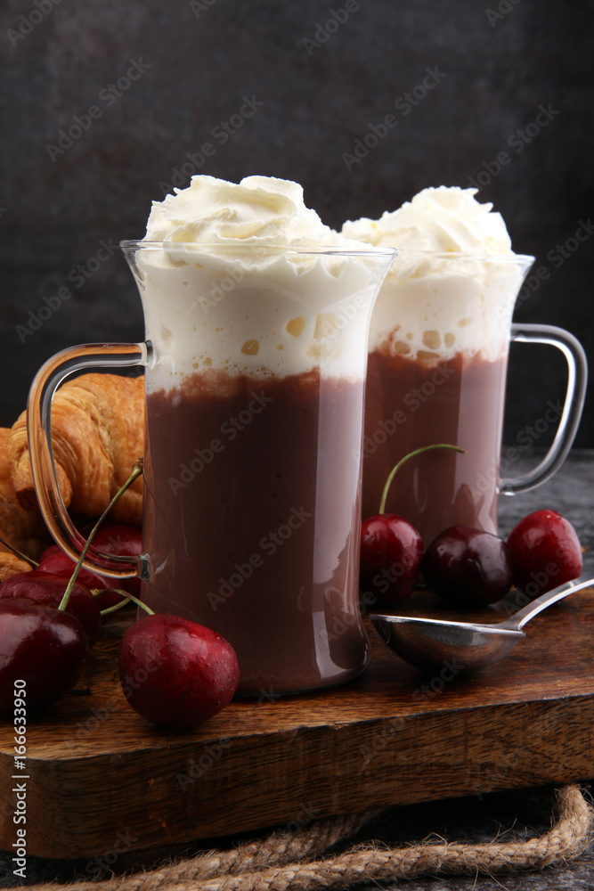 Iced coffee with whipped cream in tall glass and fresh croissant Iced coffee with whipped cream in tall glass and fresh croissant