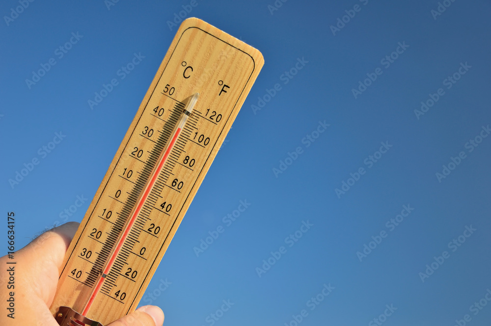 Mercury wooden thermometer shows very high temperature. Temperatures in  Celsius and Fahrenheit degrees. Hot summer weather. Forty degrees over zero  during the day. Stock Photo