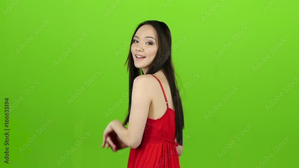 Asian girl posing in camera and she smiling. Green screen. Slow motion Asian girl posing in camera and she smiling. Green screen. Slow motion