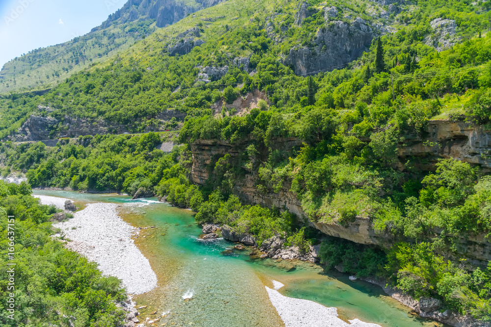 The purest waters of the turquoise color of the river Moraca flowing among the canyons. Montenegro. The purest waters of the turquoise color of the river Moraca flowing among the canyons. Montenegro.