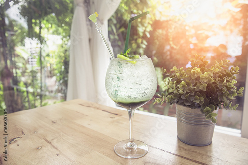 Sabrina refreshing kiwi juice with ice soda in glass with garden background,Concept of diet or healthy