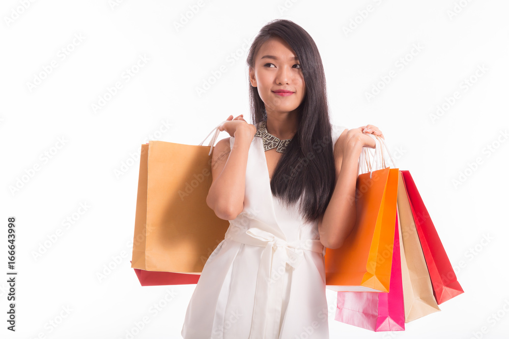 Beautiful Asian Woman holding shopping bags in hand and feeling so happiness,Isolated on white background Beautiful Asian Woman holding shopping bags in hand and feeling so happiness,Isolated on white background