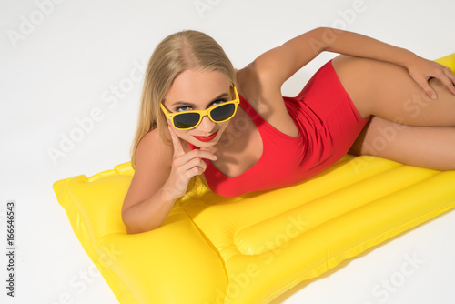 Sexy blonde on swimming mattress isolated