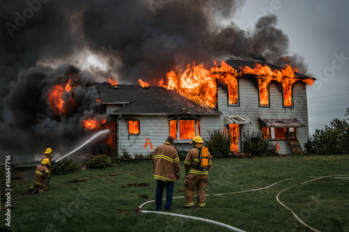 Fototapeta Fire Fighters Putting Out A House Fire