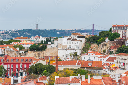 Lisbon orange roofs aerial view with 24 april bridge and Cristo Rei in the background, Portugal