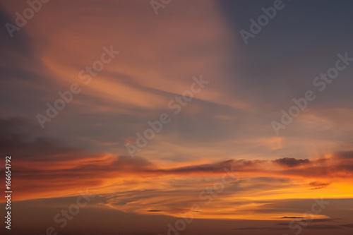 Dramatic atmosphere of beautiful romantic sunset sky and clouds. © ekapolsira