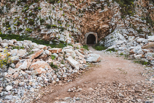 Entrance to the mountain tunnel on the way from Perazica Do to Petrovac, Montenegro. Wild rocks and stones on the path threw the mountain.