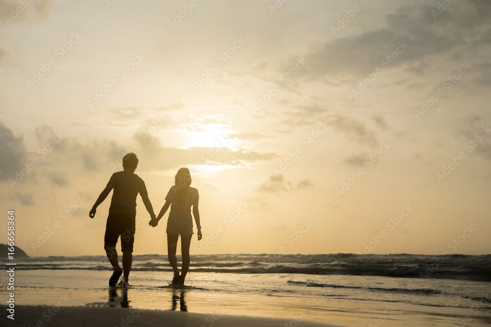 Romantic Retired Couple Relaxing on Beach Vacation at Sunset