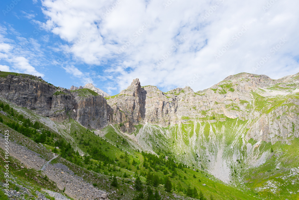 High altitude blue lake in idyllic uncontaminated environment once covered by glaciers. Summer adventures and exploration on the Italian French Alps. Expansive view from above, clear blue sky. High altitude blue lake in idyllic uncontaminated environment once covered by glaciers. Summer adventures and exploration on the Italian French Alps. Expansive view from above, clear blue sky.