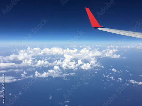 Airplane Wing above the Clouds