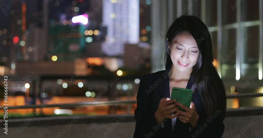 Business woman using smart phone in Hong Kong city Business woman using smart phone in Hong Kong city