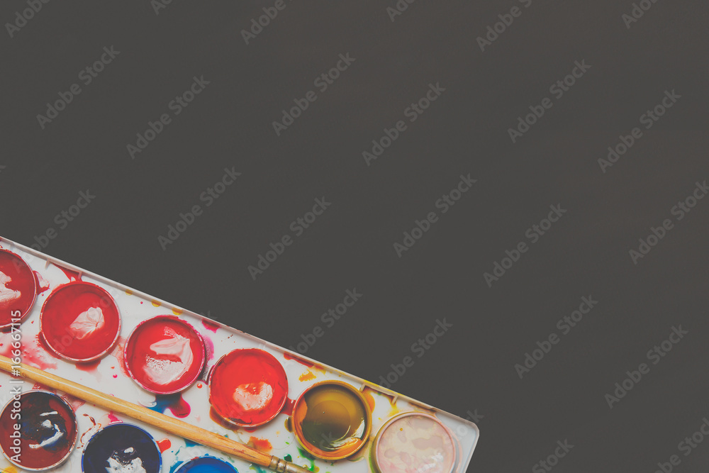 Watercolor paints in a box.