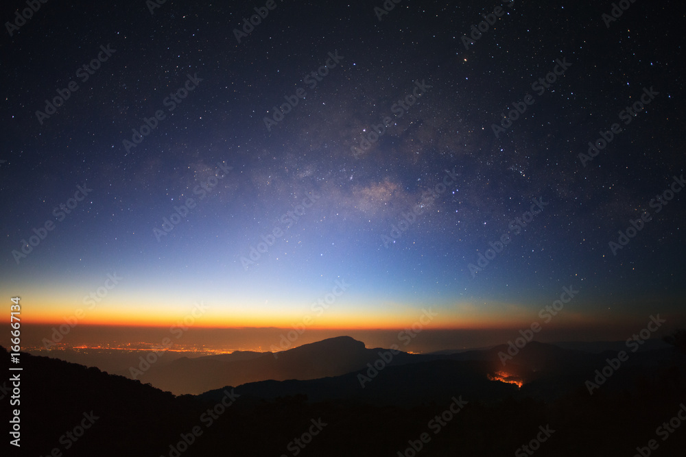 Milky Way Galaxy with light city before sunrise at Doi inthanon Chiang mai, Thailand.