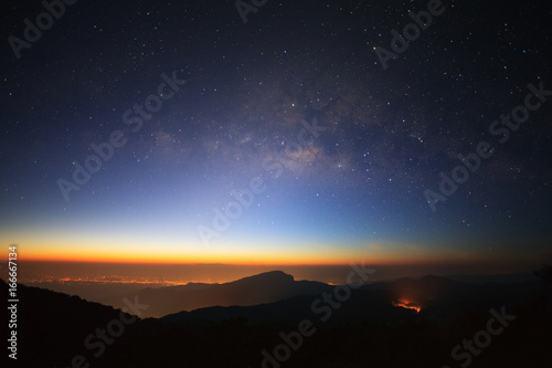 Milky Way Galaxy with light city before sunrise at Doi inthanon Chiang mai, Thailand.