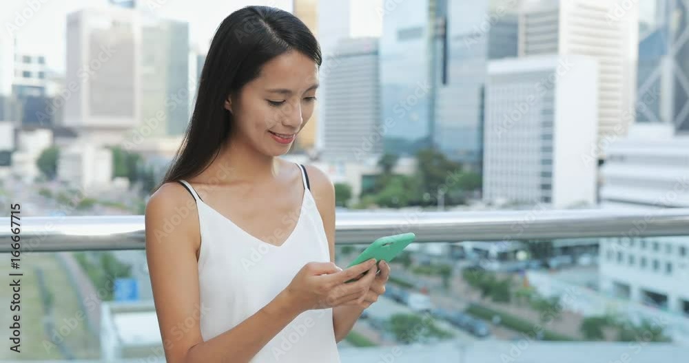 Woman sending sms of cellphone at outdoor Woman sending sms of cellphone at outdoor