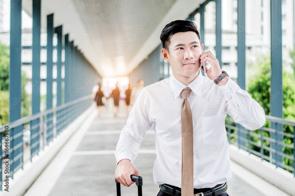 Professional businessman Travel using smartphone talking on his phone smiling happy outside walking inside in airport Professional businessman Travel using smartphone talking on his phone smiling happy outside walking inside in airport