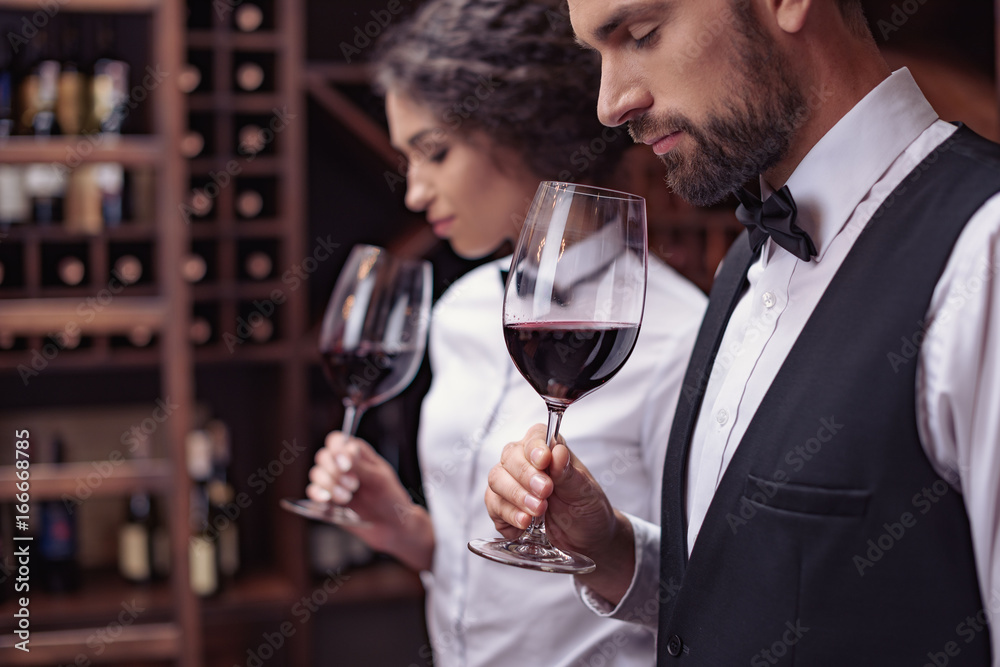 Sommeliers tasting wine in cellar Sommeliers tasting wine in cellar