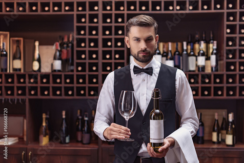 sommelier with wine and glass photo