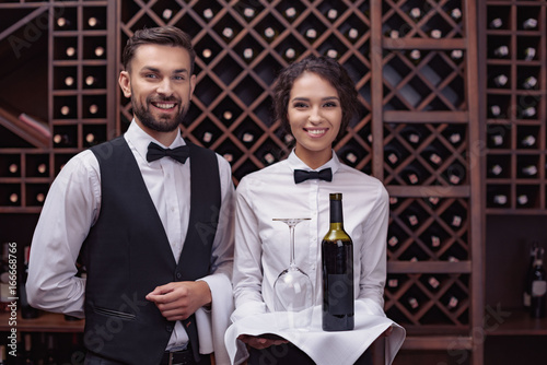 waiters with wine in cellar photo