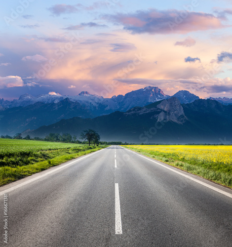 Road through countryside landscape to the mountain