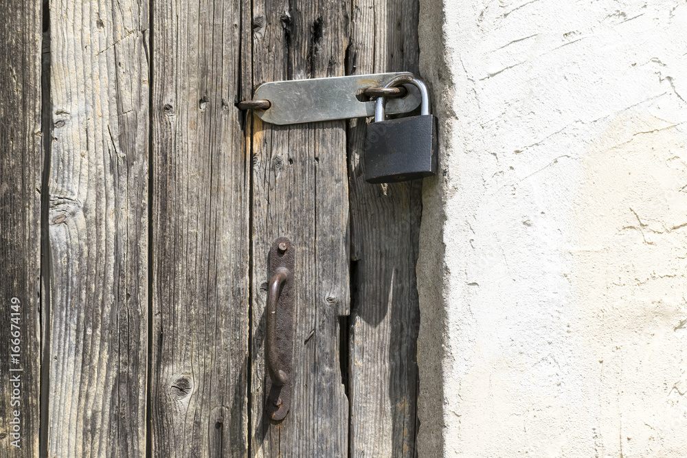 a wooden door with a padlock