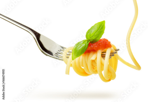 spaghetti with tomato sauce and basil on fork isolated