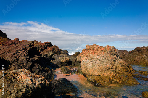 Large rock formations on sandy beach at Port Macquarie Australia © jaaske