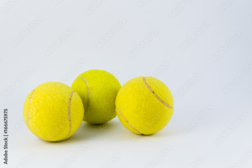 Yellow tennis balls over white with shadow below