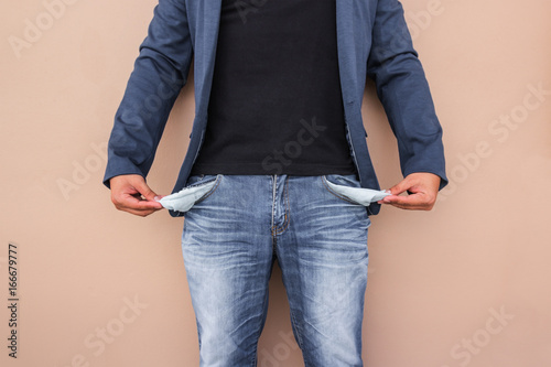 Man showing his empty pockets