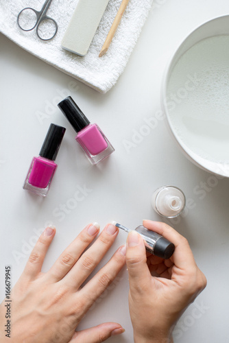 girl painting her nails at home