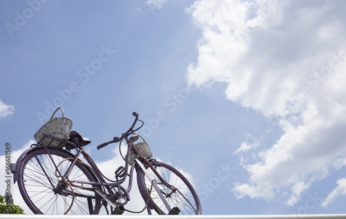 Vintage bicycle against the sky on a sunny day.