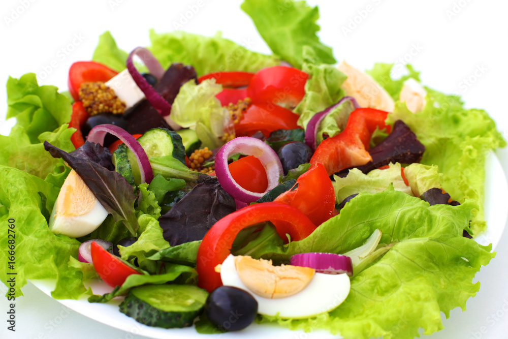 salad from fresh vegetables in a plate on a table, selective focus salad from fresh vegetables in a plate on a table, selective focus