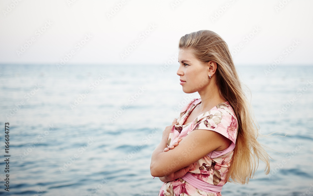 Solitude and freedom. Attractive blond female relaxing on the beach. Solitude and freedom. Attractive blond female relaxing on the beach.