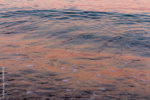 Sunrise colours reflected in sea water