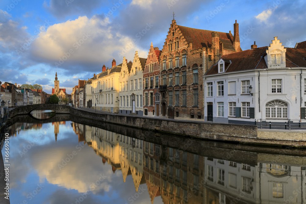Pink clouds at dawn on the Belfry and historic buildings reflected in the typical canal, Bruges, West Flanders, Belgium Pink clouds at dawn on the Belfry and historic buildings reflected in the typical canal, Bruges, West Flanders, Belgium