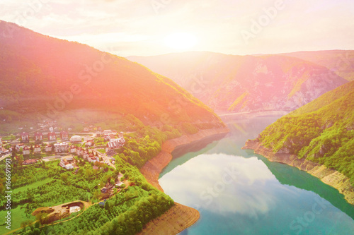 Beautiful view of the resort town in the mountains by the lake at sunset, top view