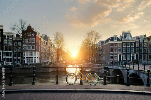 Fotótapéta Bicycles lining a bridge over the canals of Amsterdam, Netherlands
