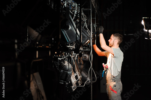 The stage worker sets up the lights