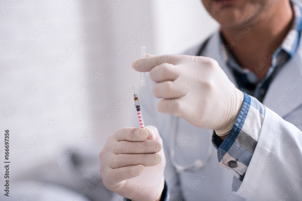 Close up of syringe that being in doctors hands Close up of syringe that being in doctors hands