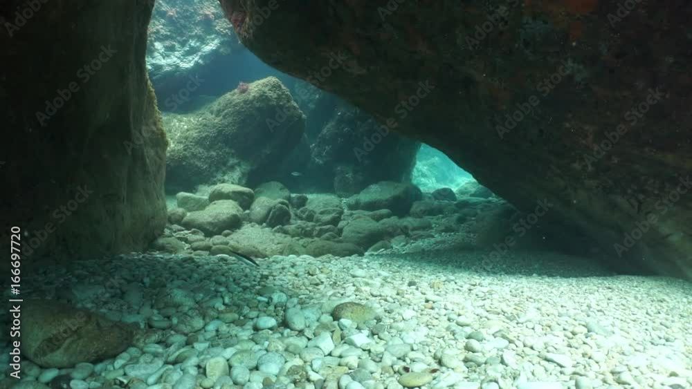Rocky seabed underwater with a small passage under big rocks, Mediterranean sea, Catalonia, Roses, Costa Brava, Spain, 60fps
