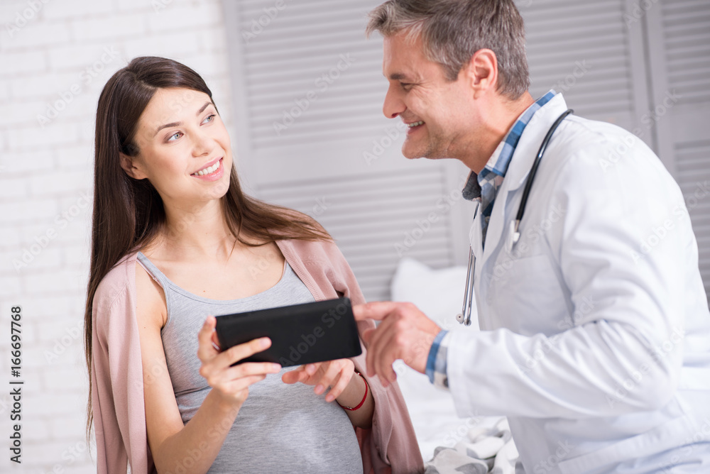 Smiling doctor talking to his patient Smiling doctor talking to his patient