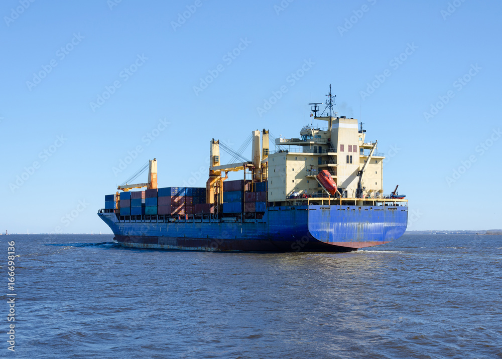 Cargo ship sailing in still water