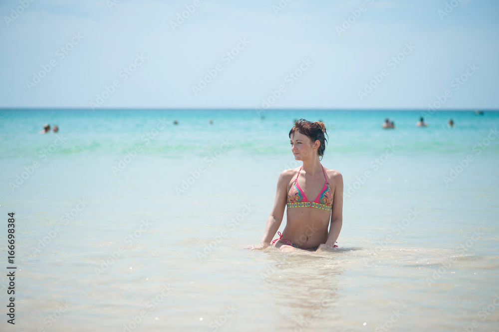 Girl in the sea looking into the distance Girl in the sea looking into the distance